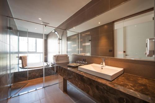 a bathroom with a sink and a mirror at Grand Crystal Hotel in Hsinchu City