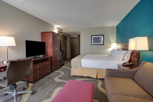 a hotel room with a bed and a tv at Holiday Inn Express Washington DC East- Andrews AFB by IHG in Camp Springs