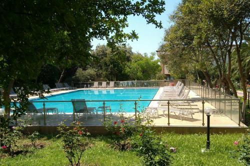 a large swimming pool with chairs at Iris Hotel in Canakkale