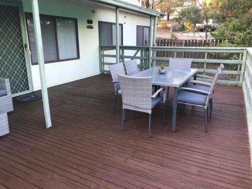 a patio with a table and chairs on a deck at Metung Getaway in Metung