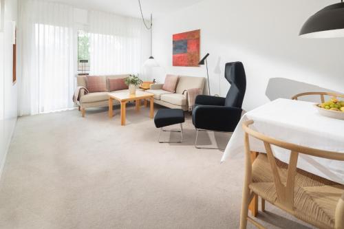 a living room with a couch and chairs at Vier Häuser in Norderney
