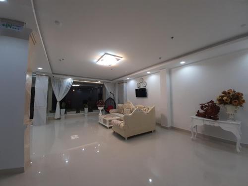 a living room with two chairs and a couch at Minh Manh Hotel 2 in Pleiku