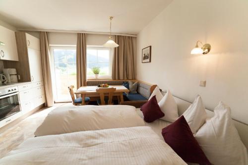 a hotel room with two beds and a table at Urlaubsland Sonnfeld in Flachau