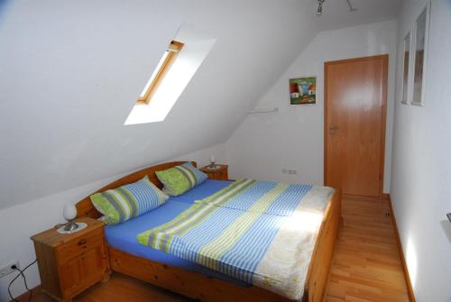 a bedroom with a bed and a skylight at Drei Tannen und Ferienhaus Schneider in Todtnau