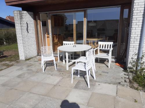 a white table and chairs on a patio at Svendborg Cosy in Svendborg