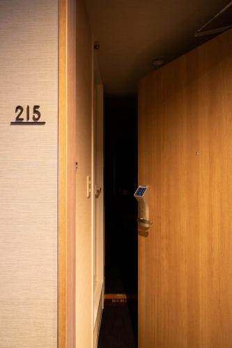 a door to a hallway with the number on it at Super Hotel Nagaizumi Numazu Inter in Nagaizumi