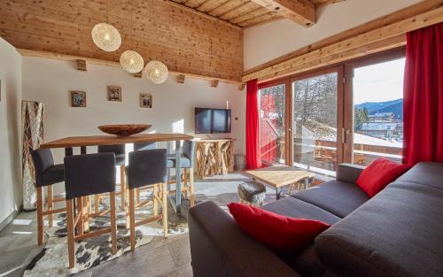 a living room with a couch and a table at Apartment Panorama in Saalbach Hinterglemm
