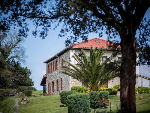 a large building with a palm tree in front of it at El Mirador de Rivas in Agüero