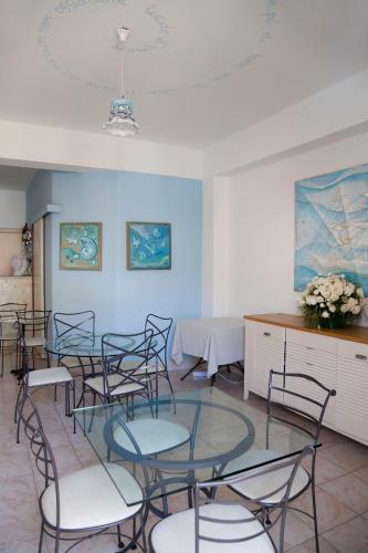 a room with chairs and a glass table and a counter at Hotel Amarea - Aeolian Charme in Canneto