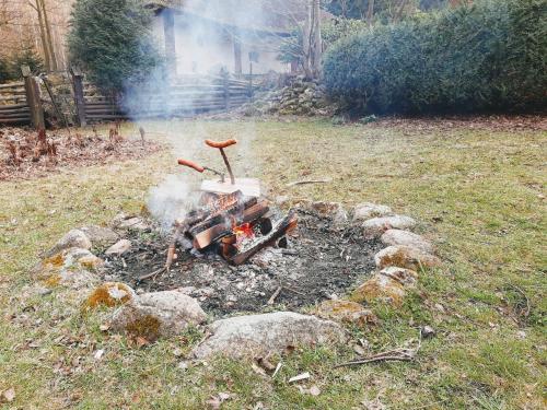 a barbecue in a yard with smoke coming out at Tumitak Sarnia Family & Friends in Karpacz