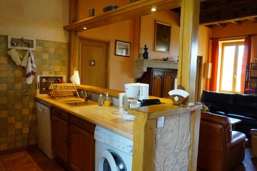 a kitchen with a sink and a dishwasher at Gîte des Grands Narreaux in Bourbon-Lancy
