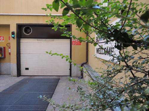 a garage with a white door and a gate at Hotel Mirage Sure Hotel Collection by Best Western in Milan