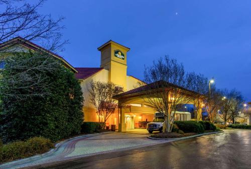 a building with a clock tower on top of it at La Quinta by Wyndham Raleigh Durham Intl AP in Morrisville