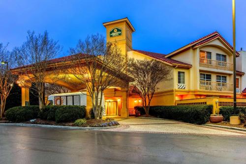 a building with a clock tower on top of it at La Quinta by Wyndham Raleigh Durham Intl AP in Morrisville