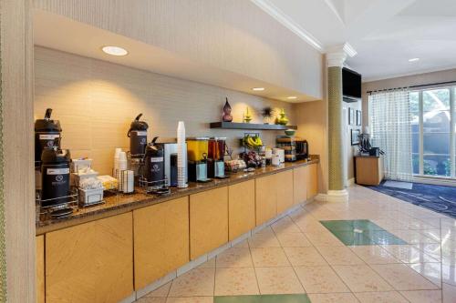 a large kitchen with a counter with many appliances at La Quinta by Wyndham Ft. Lauderdale Plantation in Plantation