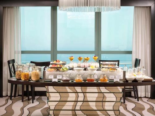 a buffet of food on a table in a room at Sofitel Abu Dhabi Corniche in Abu Dhabi