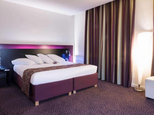 سرير أو أسرّة في غرفة في Mercure Lille Roubaix Grand Hôtel