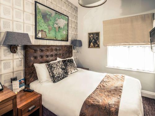 a bedroom with a large bed and a window at Mercure Nottingham City Centre Hotel in Nottingham