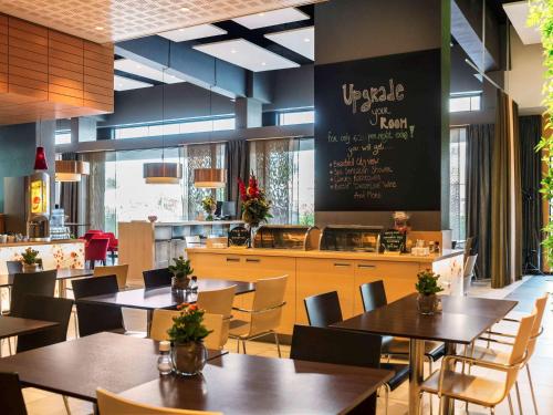 a restaurant with tables and chairs and a menu at ibis Leiden Centre in Leiden