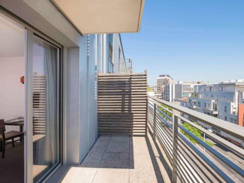 a balcony of a building with a view of a city at City Résidence Tours in Tours