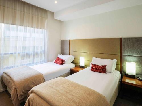 a hotel room with two beds and a window at The Sebel Launceston in Launceston