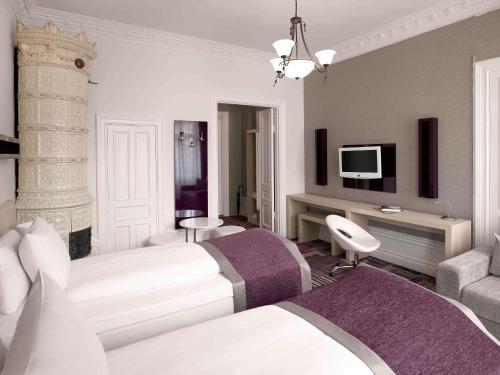 a hotel room with two beds and a tv at Ibis Styles Stockholm Odenplan in Stockholm