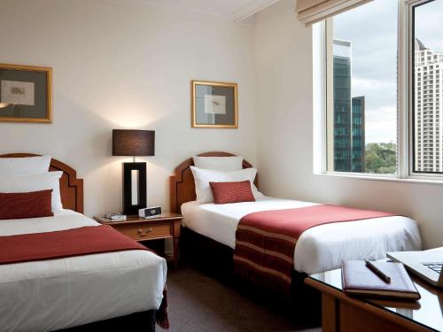 Säng eller sängar i ett rum på The Sebel Quay West Auckland