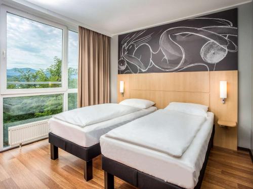 Postel nebo postele na pokoji v ubytování ibis Wörthersee