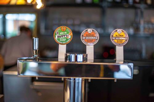 a bar with several signs on top of a counter at Apparthotel Le Hüb Grenoble in Grenoble