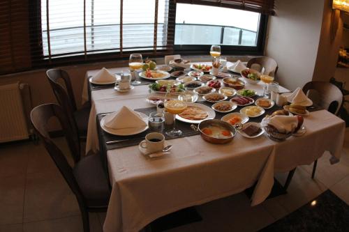 un tavolo con piatti di cibo e bicchieri di vino di Ramada by Wyndham Nigde a Nigde