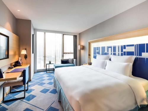 A bed or beds in a room at Novotel Ningbo East