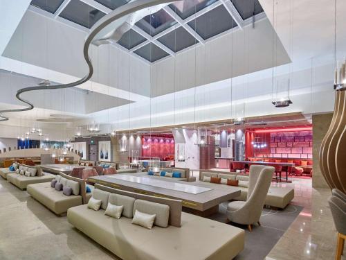a lobby with couches and tables and a restaurant at Novotel Istanbul Bosphorus Hotel in Istanbul