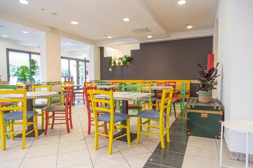 a restaurant with colorful tables and chairs at Mare Home Brunch&Beauty - Adults Only in Cesenatico