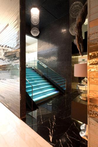 a lobby with escalators in a building with black at VIP Grand Lisboa Hotel & Spa in Lisbon