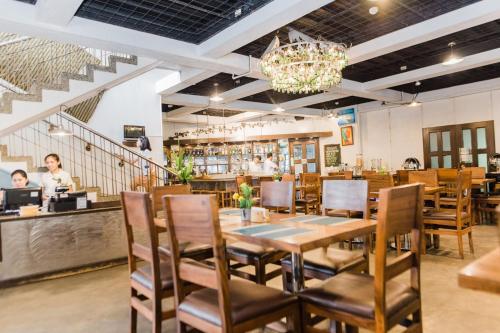 a dining room with a table and chairs in a restaurant at Nature's Village Resort in Bacolod