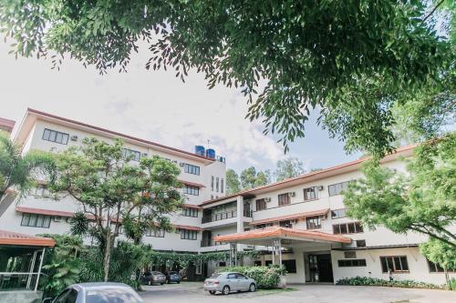 a building with a car parked in front of it at Nature's Village Resort in Bacolod