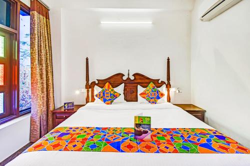 a bedroom with a bed with a colorful bedspread at FabHotel Shree Villas in Jaipur
