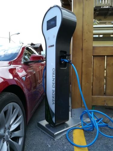 an electric car is being charged by a car charger at Hotel Amerikan in Livigno