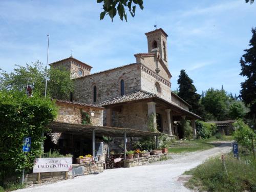 a building with a clock tower on top of it at Borgo Sicelle Residence in San Donato in Poggio