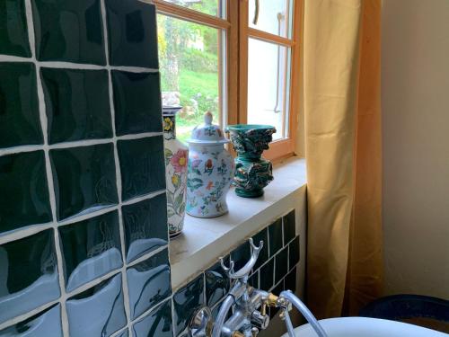 a counter with vases sitting on a window sill at Mymoustiers in Moustiers-Sainte-Marie
