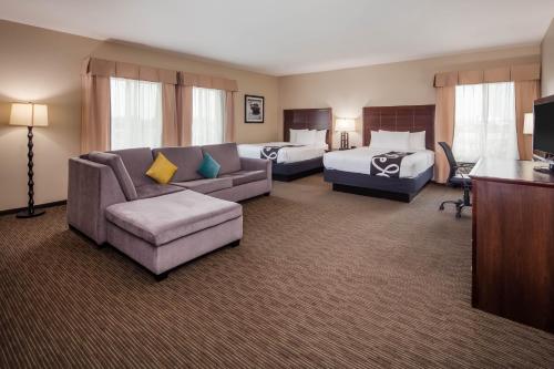 a large hotel room with two beds and a couch at La Quinta by Wyndham Inglewood in Inglewood