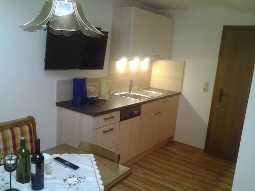 a small kitchen with a sink and a table at Appartement Harmonie & Balance in Leogang