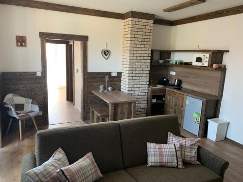 a living room with a couch and a kitchen at Apartmány Veternica v Bernarde in Smokovce