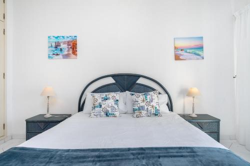 ein Schlafzimmer mit einem großen Bett mit zwei Nachttischen in der Unterkunft Praia da Rocha, 605 Concorde, Charming Apartment with Sea View, Internet and Parking, By IG in Portimão