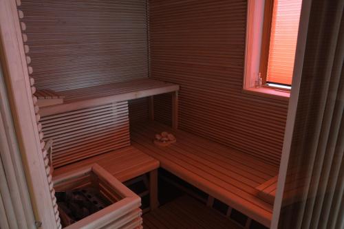 a sauna with a wooden bench and a window at SECRET WELLNESS in Bodonci