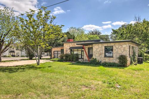 a stone house with a green yard at Retro Updated Blanco Abode - Steps to Main Street! in Blanco