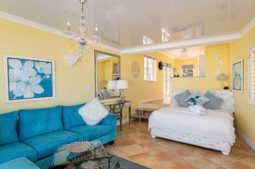 a living room with a blue couch and a table at Haus am Strand - on the Beach in Wilderness