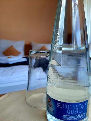 a bottle of water sitting on top of a table at Hotel Landgasthof Frankenstern in Gößweinstein