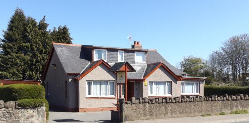 a house with a fence in front of it at Lyndon Guest House in Inverness