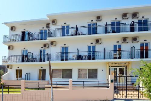 an apartment building with blue windows and balconies at Despoina in Skiathos Town
